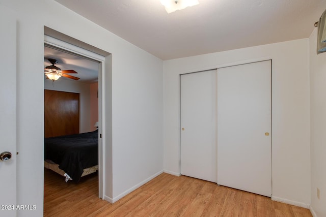 unfurnished bedroom featuring a closet, ceiling fan, and light hardwood / wood-style flooring