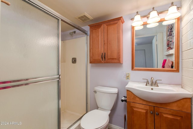 bathroom featuring toilet, vanity, and walk in shower