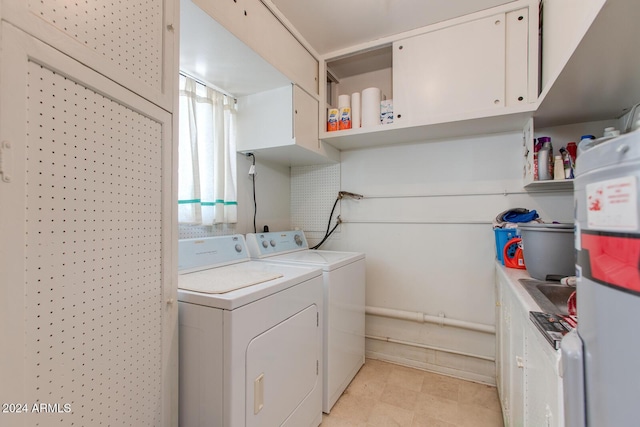 laundry area featuring cabinets and washing machine and clothes dryer