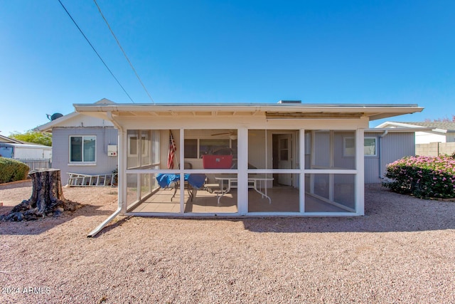 back of house featuring a sunroom