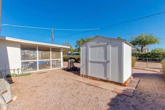 view of outdoor structure featuring a sunroom