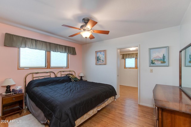 bedroom with light hardwood / wood-style flooring, multiple windows, and ceiling fan