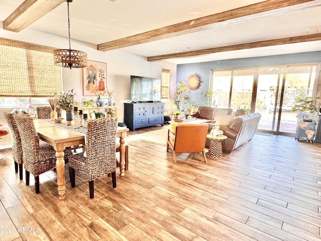 dining space with beamed ceiling, a notable chandelier, and light wood-type flooring