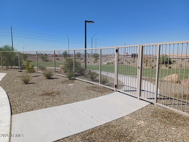 view of home's community with fence and a gate