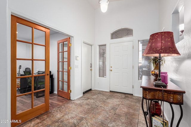 entrance foyer with a towering ceiling and french doors