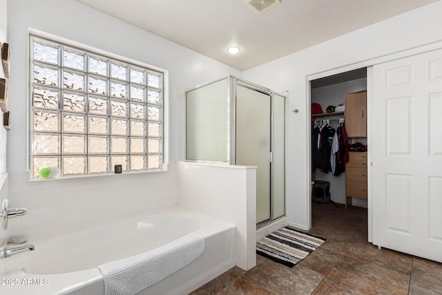 bathroom featuring independent shower and bath