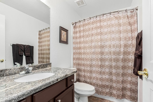 bathroom with vanity, toilet, and walk in shower