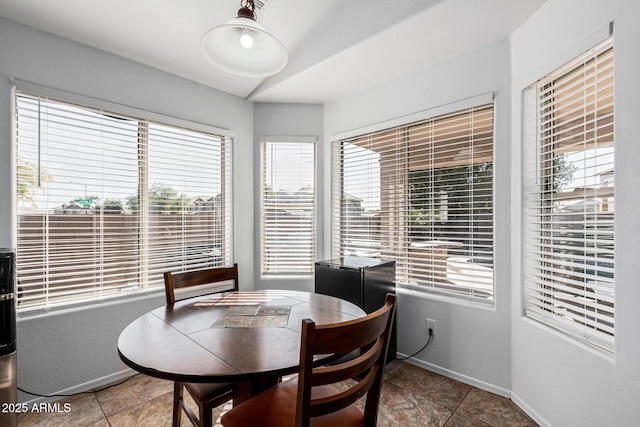 dining room with a wealth of natural light and tile patterned flooring