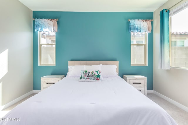 bedroom featuring light colored carpet