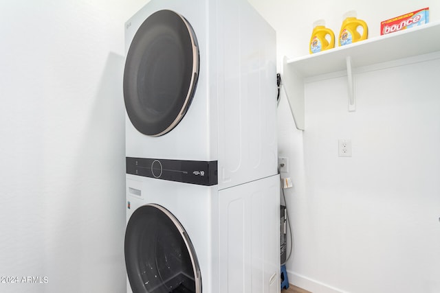 laundry area with stacked washer and dryer