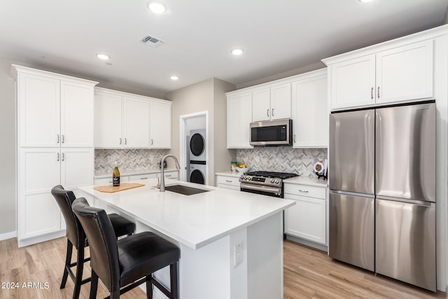 kitchen featuring sink, white cabinets, tasteful backsplash, and stainless steel appliances