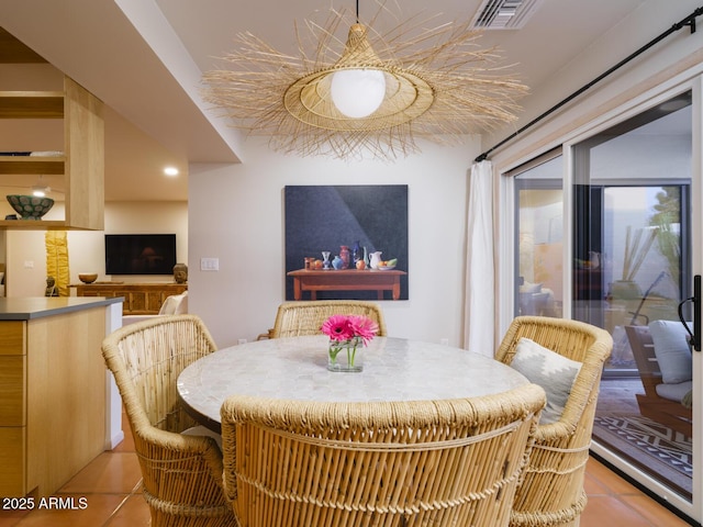 dining room with light tile patterned flooring and visible vents