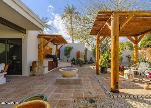 view of patio / terrace featuring grilling area, fence, an outdoor kitchen, and a pergola