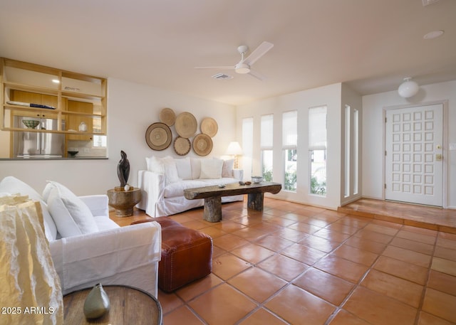 tiled living area featuring visible vents and a ceiling fan