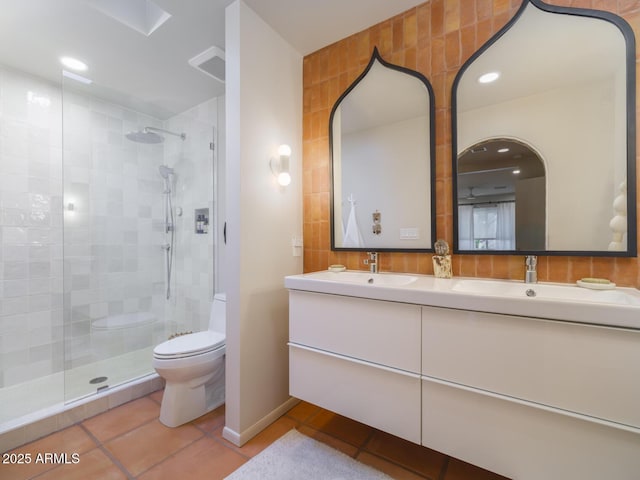 full bathroom featuring toilet, tile patterned flooring, a sink, and tiled shower