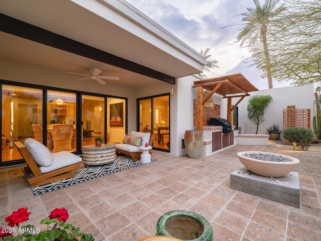 view of patio / terrace featuring area for grilling, an outdoor kitchen, and a ceiling fan