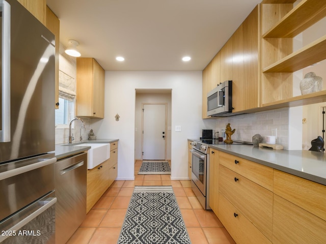 kitchen featuring light tile patterned floors, appliances with stainless steel finishes, and backsplash