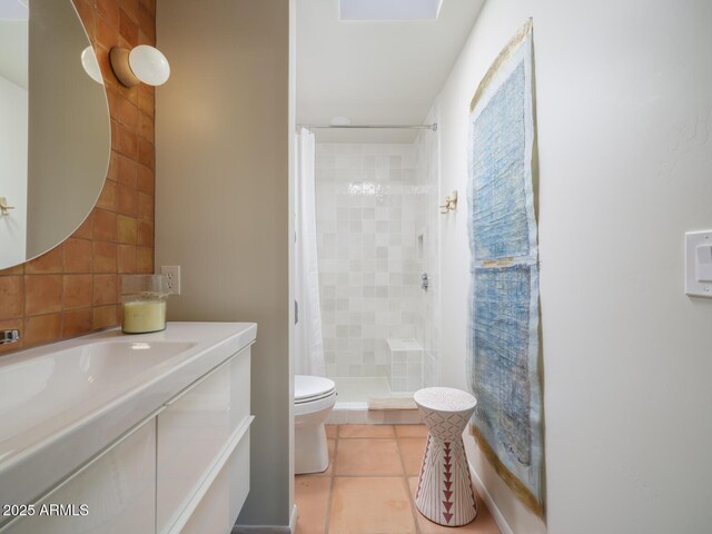 bathroom featuring toilet, tile patterned floors, a shower stall, and vanity