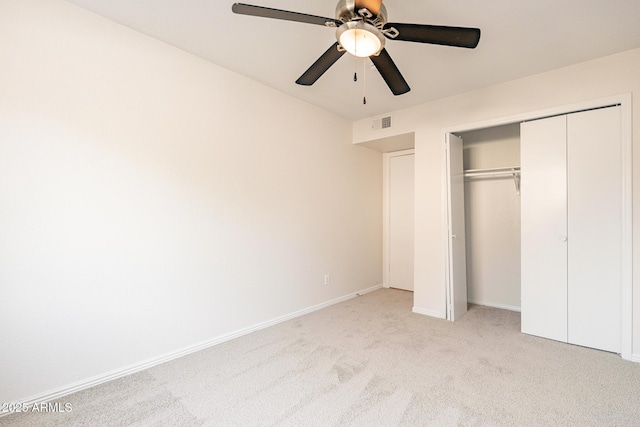 unfurnished bedroom with ceiling fan, a closet, and light colored carpet