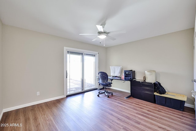 office featuring wood finished floors, a ceiling fan, and baseboards