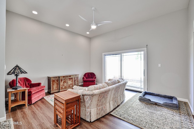 living room featuring ceiling fan, baseboards, wood finished floors, and recessed lighting