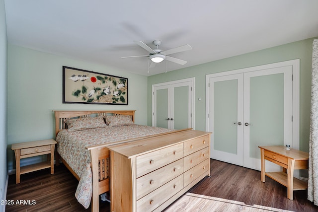 bedroom featuring french doors, dark wood finished floors, and a ceiling fan