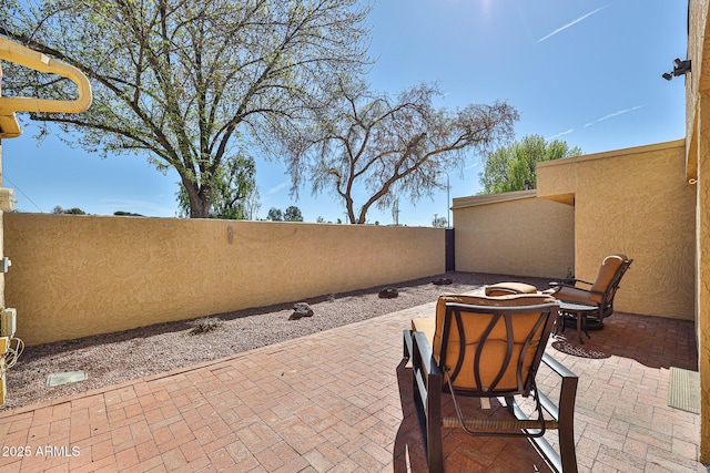 view of patio / terrace featuring fence