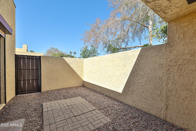 view of patio with a gate and fence