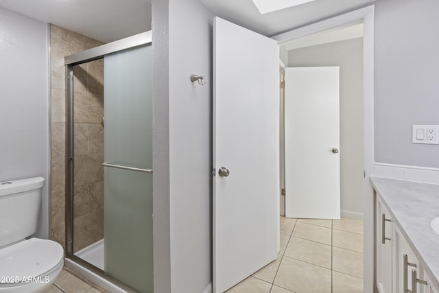 bathroom featuring vanity, toilet, an enclosed shower, and tile patterned flooring