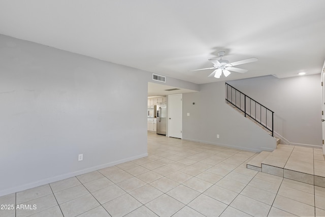 unfurnished room featuring light tile patterned floors and ceiling fan