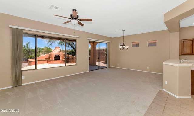 42122 N Anthem Springs Rd, Anthem, AZ 85086 - unfurnished living room featuring a chandelier, a ceiling fan, and light colored carpet