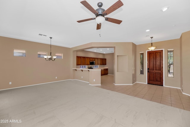 42122 N Anthem Springs Rd, Anthem, AZ 85086 - unfurnished living room featuring light colored carpet, a chandelier, a ceiling fan, recessed lighting, and light tile patterned floors