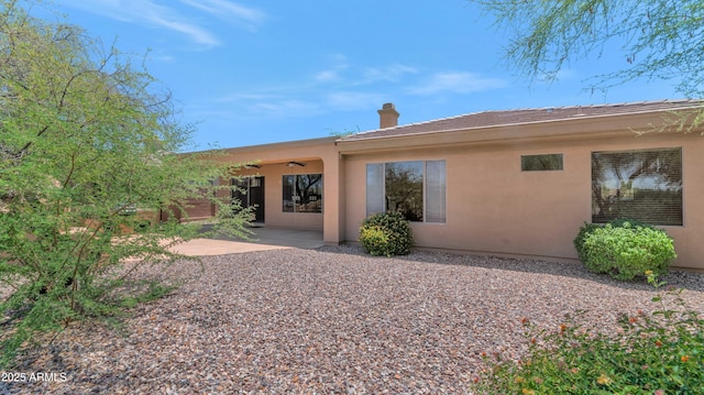 42122 N Anthem Springs Rd, Anthem, AZ 85086 - rear view of house with ceiling fan, stucco siding, a chimney, and a patio area