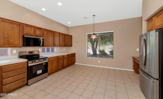 42122 N Anthem Springs Rd, Anthem, AZ 85086 - kitchen featuring appliances with stainless steel finishes, brown cabinetry, healthy amount of natural light, pendant lighting, and recessed lighting