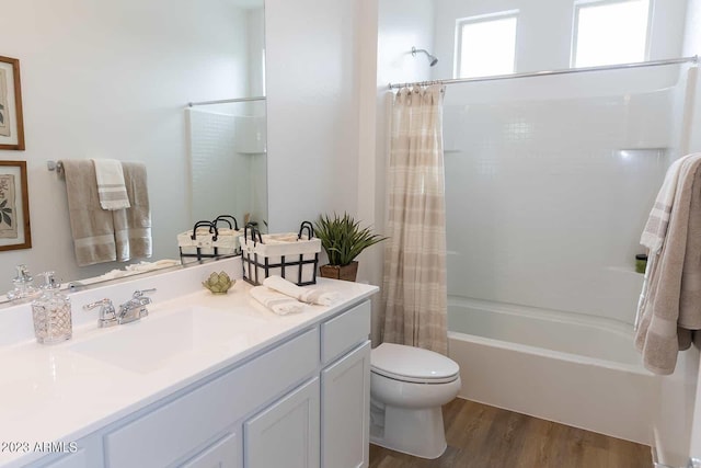 full bathroom featuring shower / bath combination with curtain, vanity, hardwood / wood-style flooring, and toilet