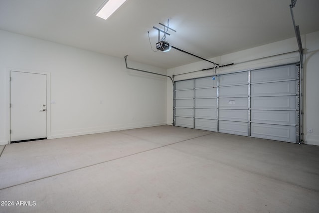 garage with a garage door opener and baseboards