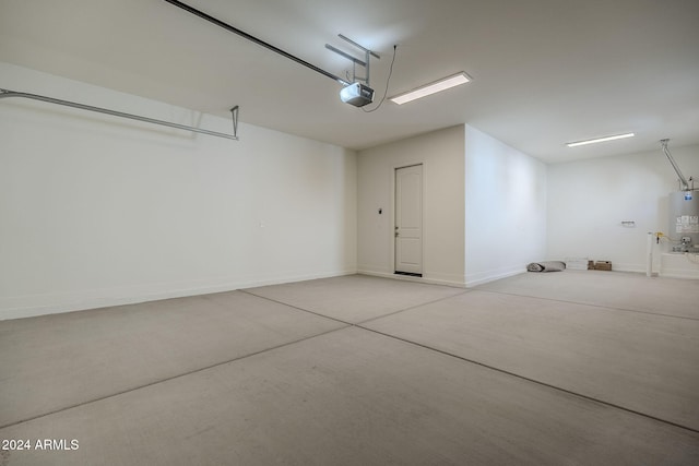 garage featuring baseboards, gas water heater, and a garage door opener