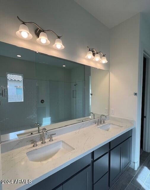 bathroom with a washtub, a stall shower, a sink, and double vanity