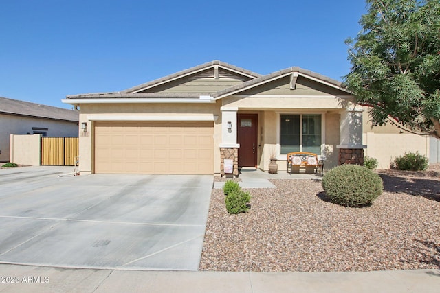 5724 N 108th Ave, Phoenix, AZ 85037 - view of front facade featuring driveway, stucco siding, covered porch, stone siding, and an attached garage