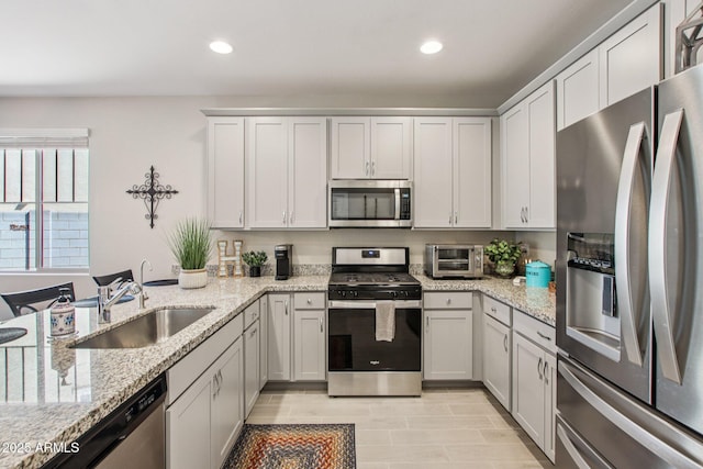 5724 N 108th Ave, Phoenix, AZ 85037 - kitchen with appliances with stainless steel finishes, light stone counters, recessed lighting, and a peninsula