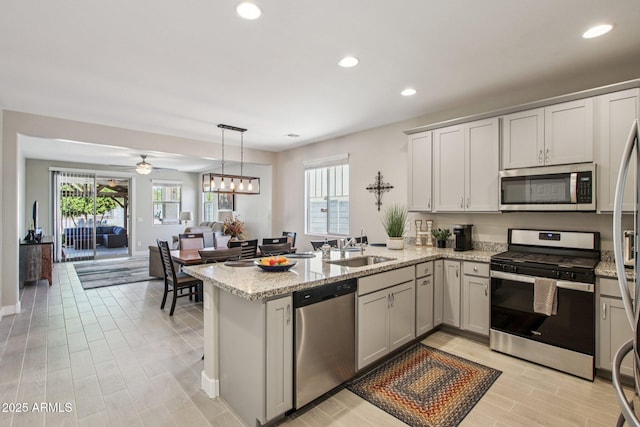 5724 N 108th Ave, Phoenix, AZ 85037 - kitchen with stainless steel appliances, a peninsula, healthy amount of natural light, recessed lighting, and open floor plan