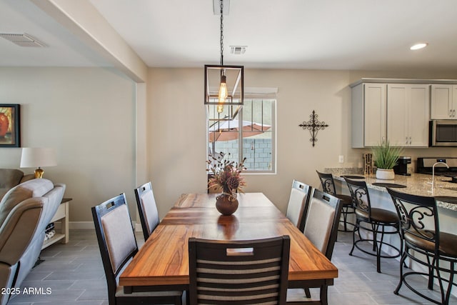 5724 N 108th Ave, Phoenix, AZ 85037 - dining area with recessed lighting and baseboards