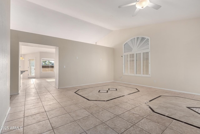 spare room featuring lofted ceiling, a ceiling fan, and baseboards