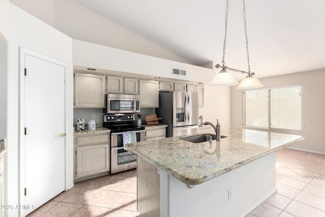 kitchen with stainless steel appliances, lofted ceiling, a sink, and light tile patterned floors