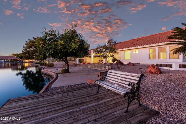 dock area featuring a water view and a patio