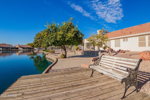 dock area with a water view, a patio area, and a gazebo