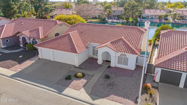 drone / aerial view with a water view and a residential view