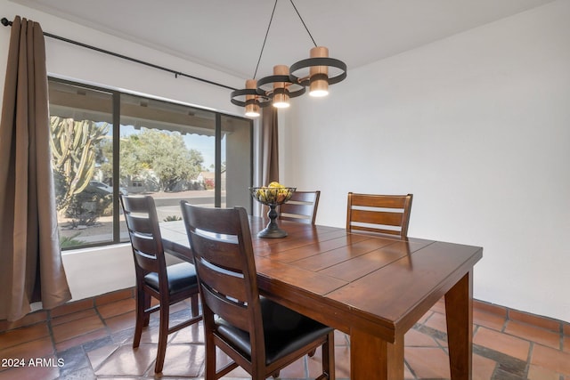 dining room featuring tile patterned flooring, a chandelier, and plenty of natural light