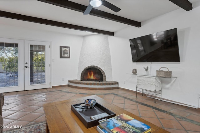 unfurnished living room with french doors, a brick fireplace, tile patterned floors, ceiling fan, and beam ceiling