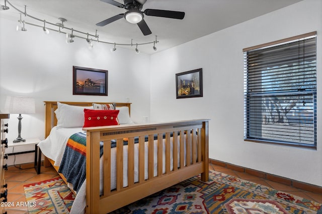 bedroom featuring tile patterned floors and ceiling fan